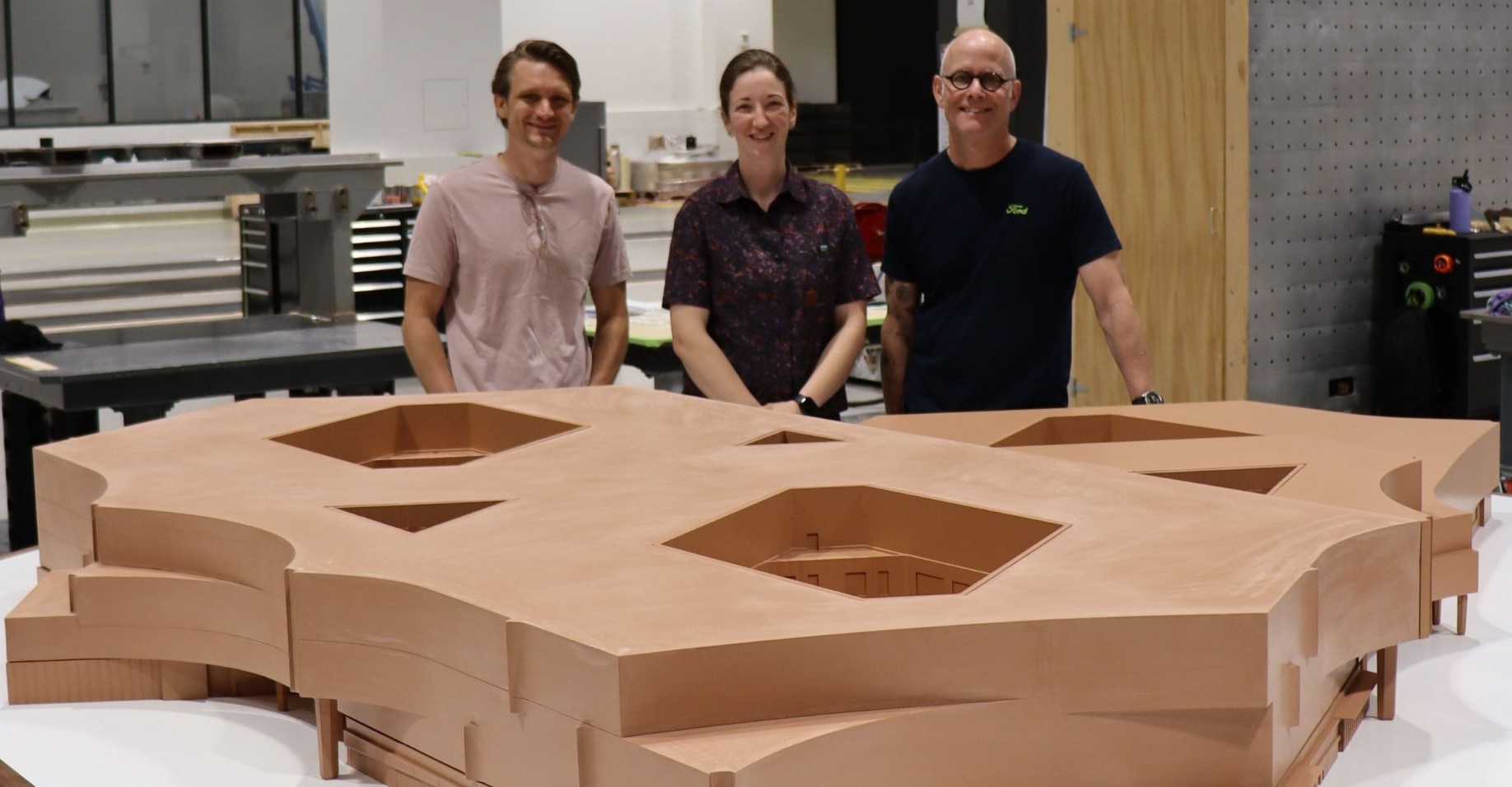 Lead Clay Sculptor Jeff Royer (right), Clay Sculptor Sean VandenBrink (left), and Lead Sculptor Anna Burke stand with the completed clay model of the new World Headquarters building, a project five weeks in the making that involved a total of more than 30 Ford team members. The model will remain on display at the new WHQ following a grand opening event on Sept. 15. 